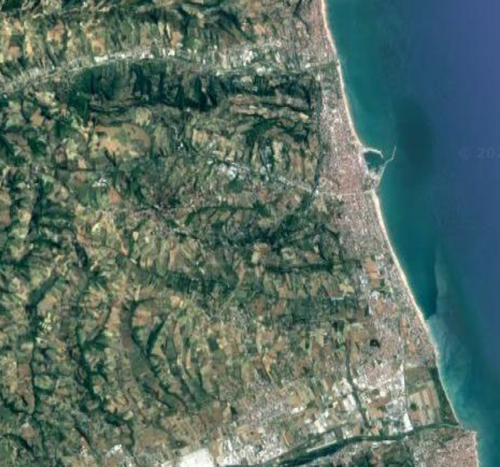 Aerial view of a land and water

Description automatically generated